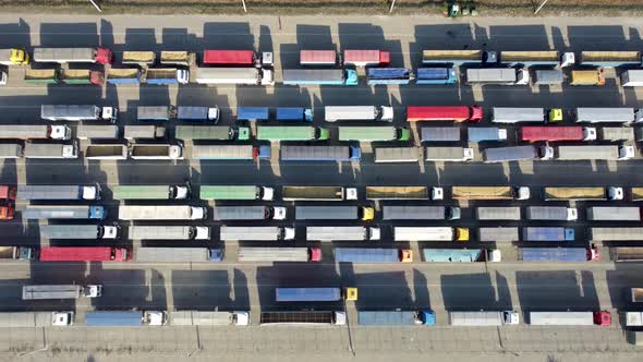 Top View of Many Trucks with Trailers Waiting to Be Unloaded at the Port Terminal