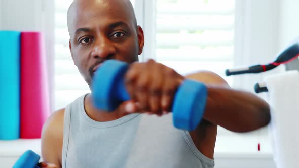Man exercising with dumbbells 4k