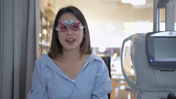 Optical shop concept. The ophthalmologist is measuring the customer's eyes. 4k Resolution.