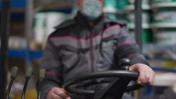 Closeup Forklift Steering Wheel with Male Caucasian Hands on It