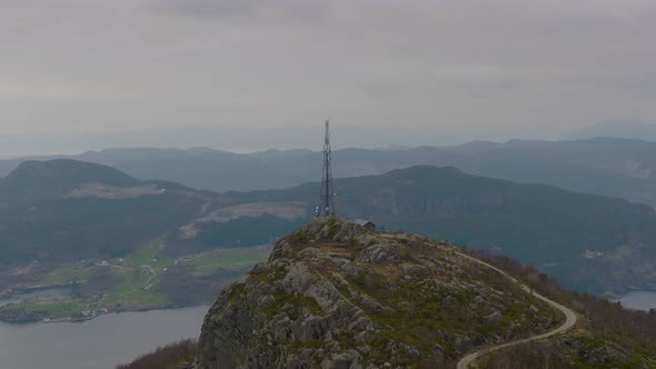 Telephone, 5G and communications tower on mountain peak. View of mountain range in the background.4