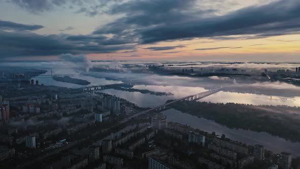 Aerial View of Dark Rainy City in the Evening Traffic After Sunset Cloudy Sky Buildings and Two