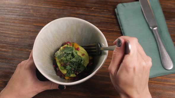 Food New Nordic Cuisine and People Concept Woman Eating Breaded Fish Fillet with Tartar Poke Salad