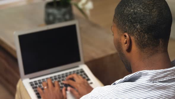 Man using laptop at home 4k