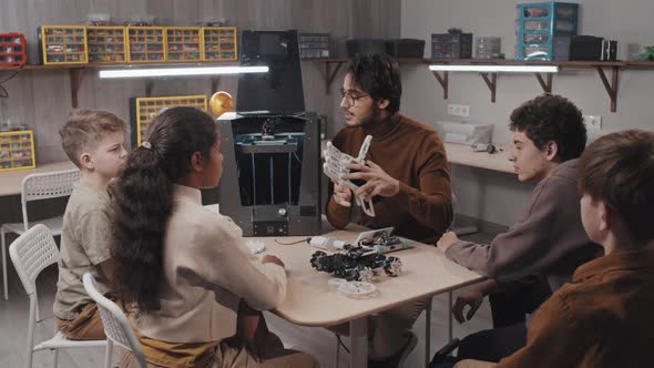 Teacher Demonstrating Robotic Hand alt