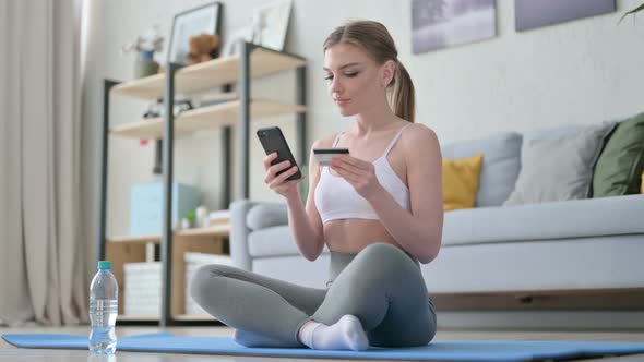 Woman Making Online Payment on Smartphone on Yoga Mat