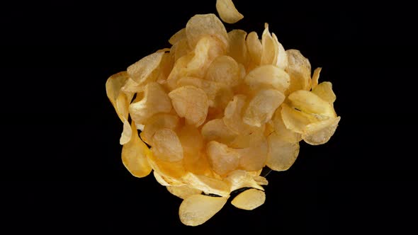 Super Slow Motion Shot of Rotating Exploded Salted Potato Chips on Black at 1000Fps
