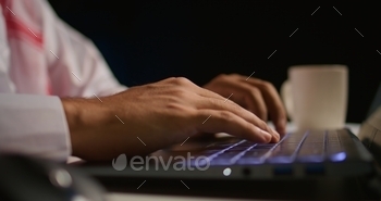 Man typing on laptop, sending emails