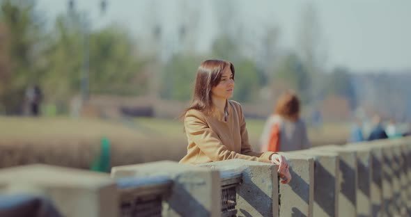 Brunette Girl Enjoying the View From the Parapet