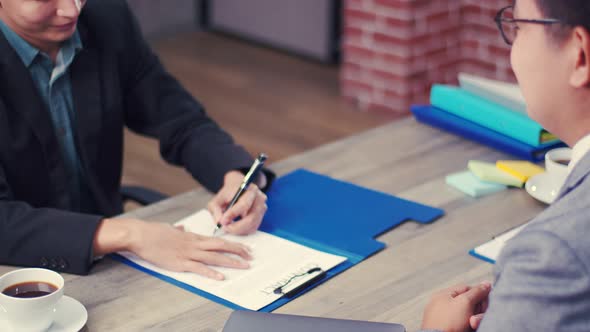 Confident executive asking candidate question new employee and sign contract