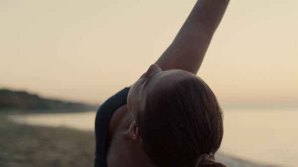 Sportswoman Practicing Triangl Asana on Beach Close Up