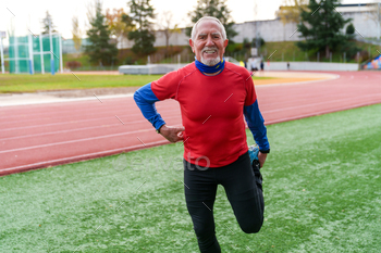 Joyful Senior Runner Enjoying a Sprint on Athletic Field