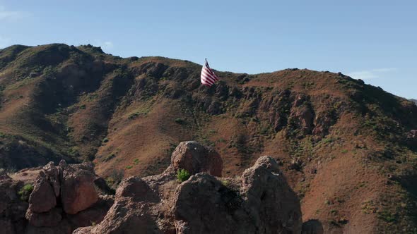 Drone Flying Around the Striped Flag Set Up in the Rocky Mountain, Malibu USA