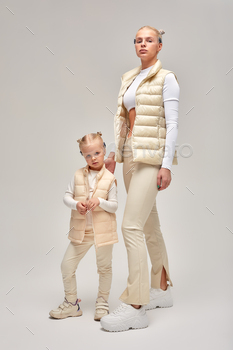 Wearable technology concept. Young woman with her little daughter in a white high-tech clothes