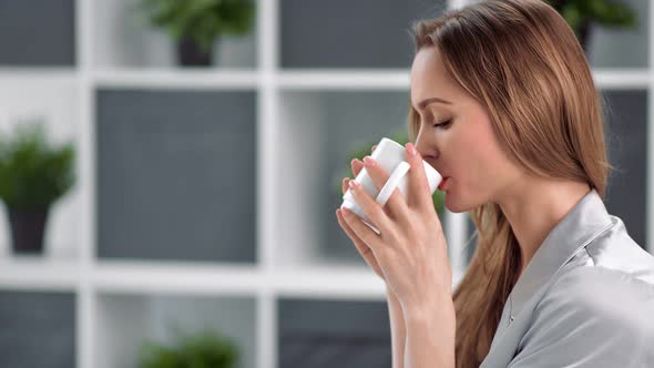 Domestic Woman Smiling Drinking Morning Coffee at Bedroom