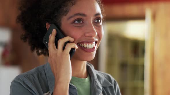 Laughing African woman talking by phone