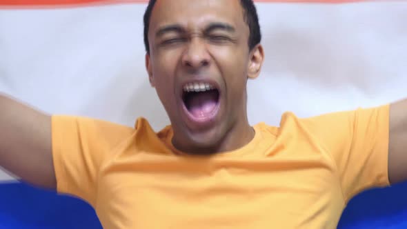 Netherlands Fan Celebrates Holding the Flag of Netherlands in Slow Motion