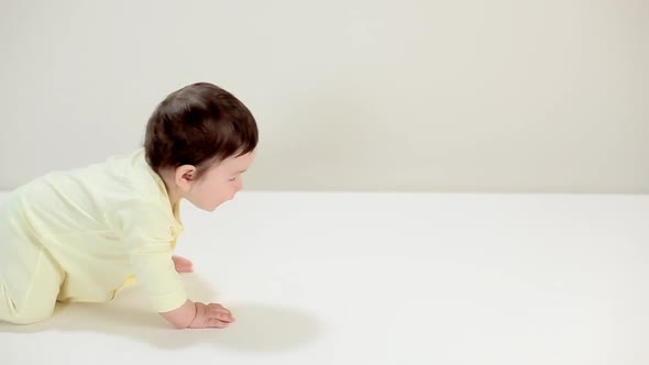 Baby boy crawling past camera