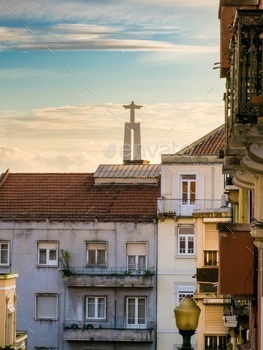 Buildings with Jesus monument in the background in Lisbon, Alcantara, Portugal.