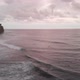 Aerial view over the beach with lots of people surfing on strong waves in Bali - VideoHive Item for Sale