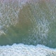 Horizontal Aerial Pan Looking Down Across Powerful Ocean Waves Breaking on The Sandy Beach - VideoHive Item for Sale