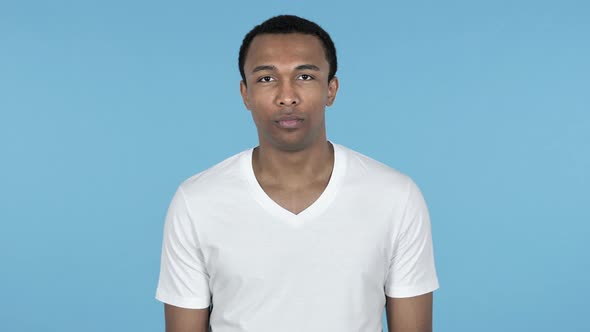 African Man Looking at Camera, Blue Background