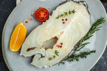 Fresh Raw cod loin fillet steaks on a dark background. banner, menu, recipe place for text, top view