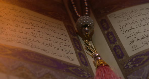 Holy Quran On Book Rest With Prayer Beads
