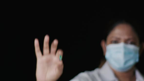 Nurse Holds Up Green Capsule