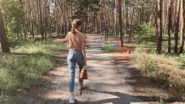 Woman goes through the park and turning around