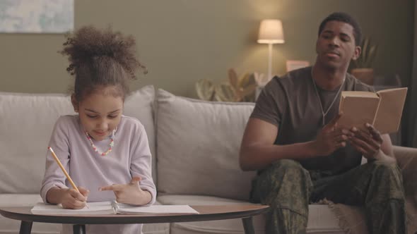 Father and Daughter Doing Homework Together alt