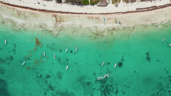 Establisher Shot of Busy Tropical Beach with Empty and Sailing Boats Along with Unrecognized Tiny