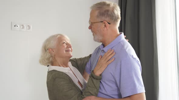 Closeup of a Beautiful Elderly Married Couple Enjoying Time Together and Dancing in the Living Room