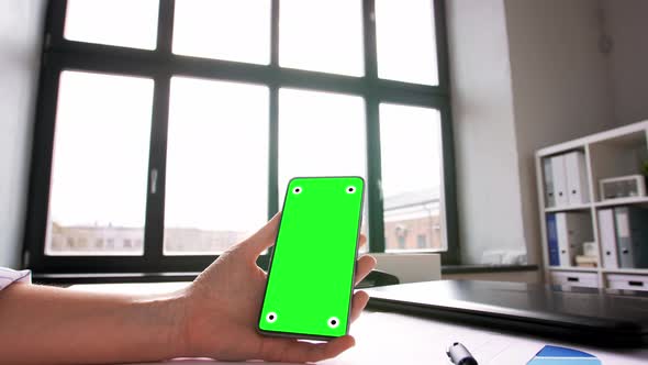 Hand with Green Screen on Phone at Home Office