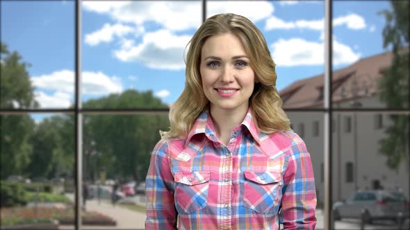 Portrait of Young Smiling Woman Looking at Camera