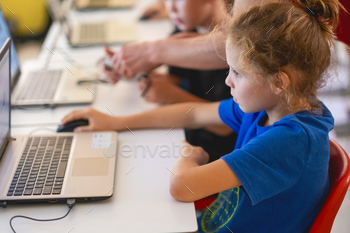 School boy learning coding digital program during computer science lesson