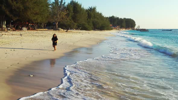 Woman sunbathes on paradise island beach voyage by turquoise sea and white sandy background of the M