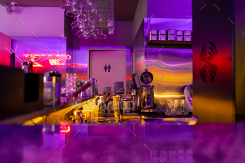 the interior of a Korean institution in neon color in a restaurant tables a bar counter