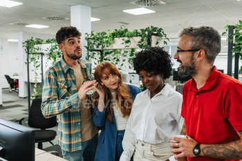 An interracial team is discussing global market at the office.