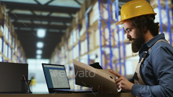 Shipping manager for operations verifies cargo details on files