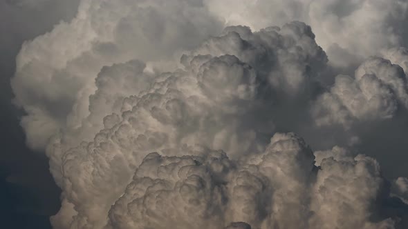 Time lapse of voluminous white clouds over blue sky