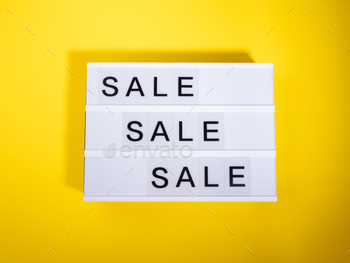 Sale store concept with lightbox text on yellow background