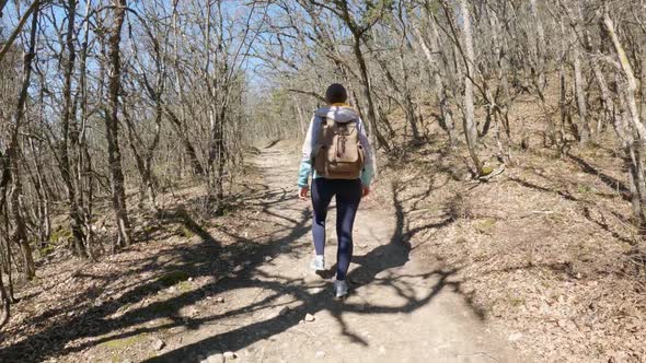 Young Trendy Woman Walking on Summer Forest Path Trail