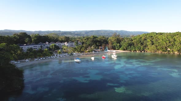 Aerial view of boats in cove by resort  in Jamaica