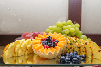 Eating at event. Catering Fruit Selection on Reflective Glass Platter. Banner for site