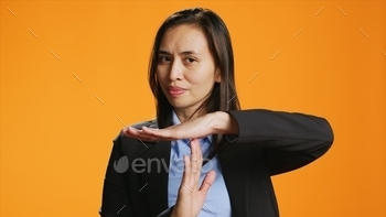 Young woman showing timeout symbol in studio