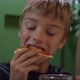 Cute Boy Taking Big Bite of Cheese Pizza at Restaurant - VideoHive Item for Sale