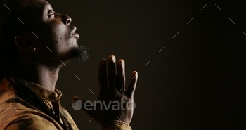 Religious adult believing in Jesus and praying in studio