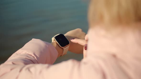 Close Up Touch Screen Wearable Technology Smart Band On Wrist Outdoor. Girl Using Smart Watch .