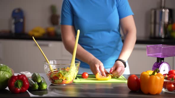 Adult Woman Preparing Vegetable Salad in Kitchen